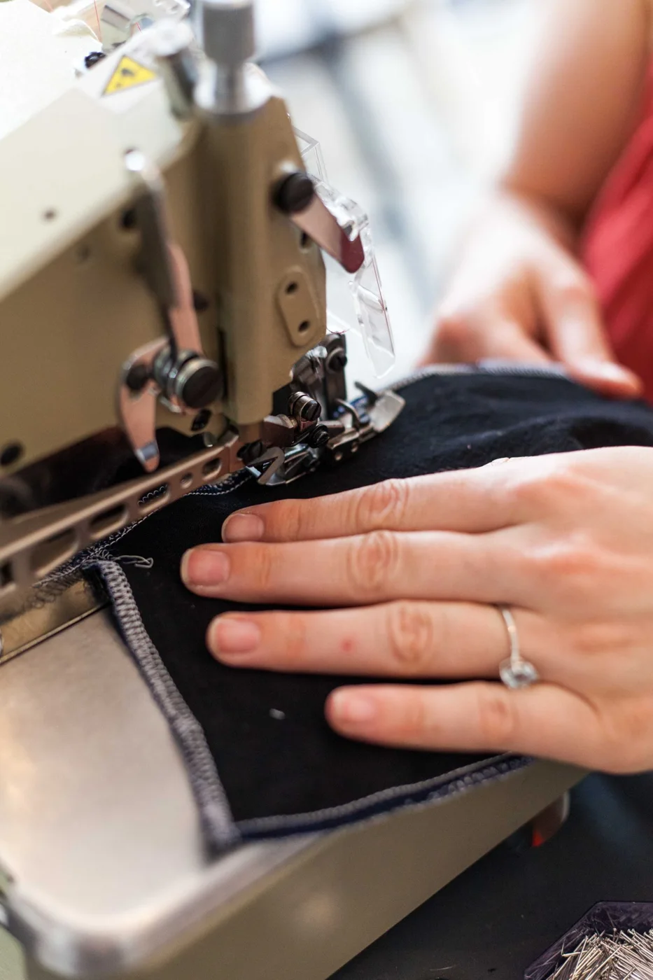 Close-up of fabric being worked on at a sewing machine