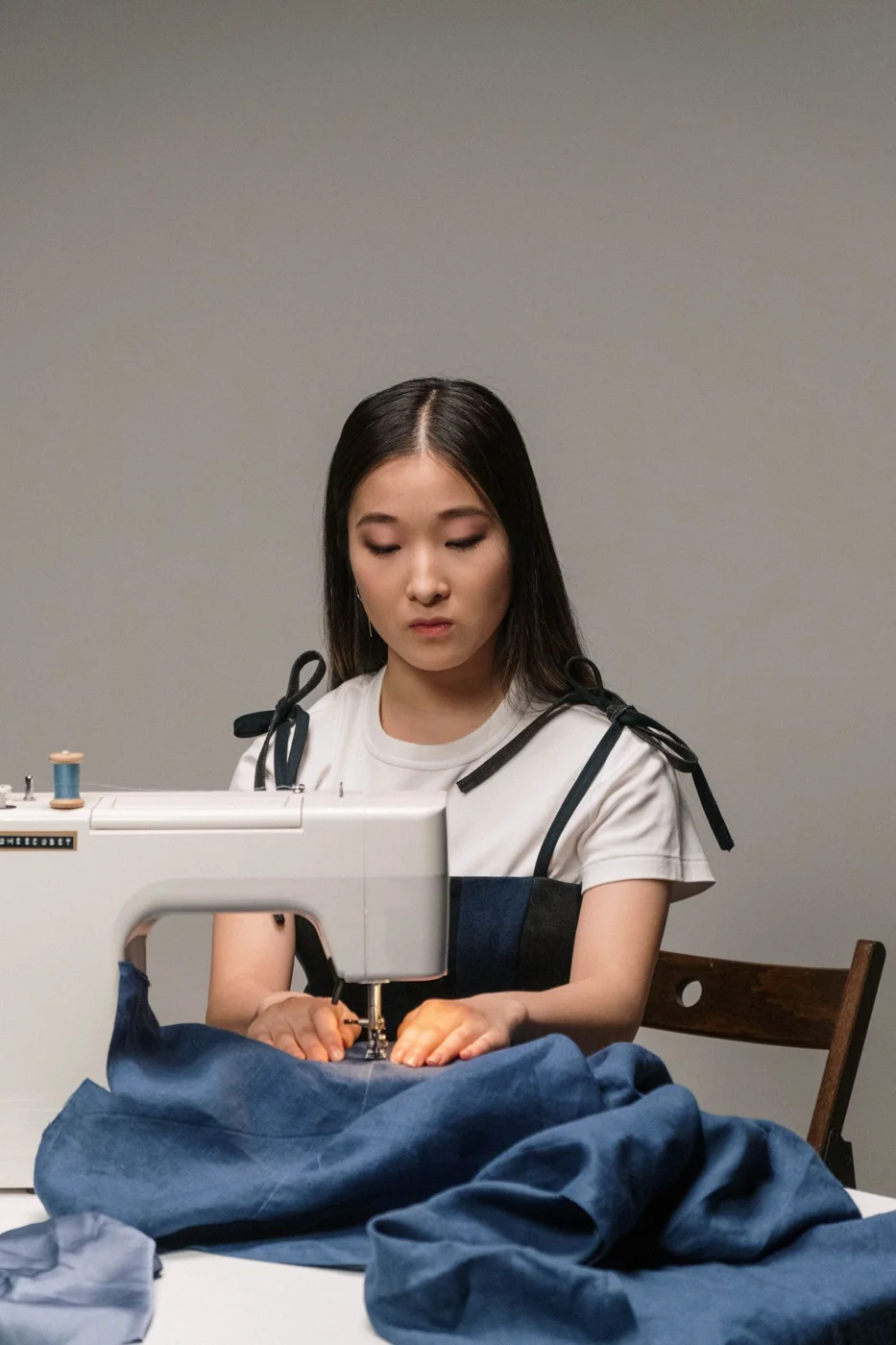 A seamstress working with denim fabric
